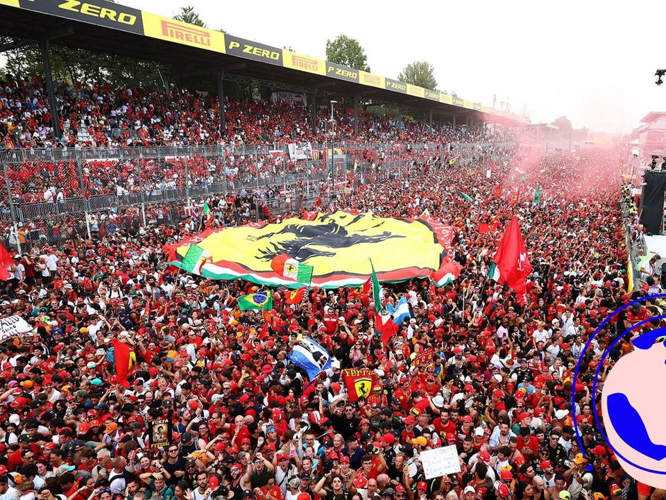 Ferrari Tifosi fans pack the pit straight and grandstands, creating an atmosphere the f1 paddock club can't replicate.