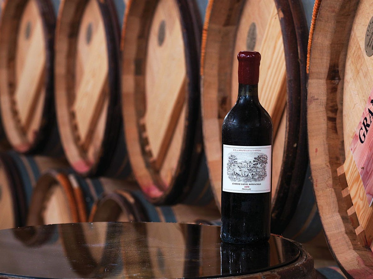 Château Lafite Rothschild: A vintage bottle on a barrel, a reminder of allocation relationships.