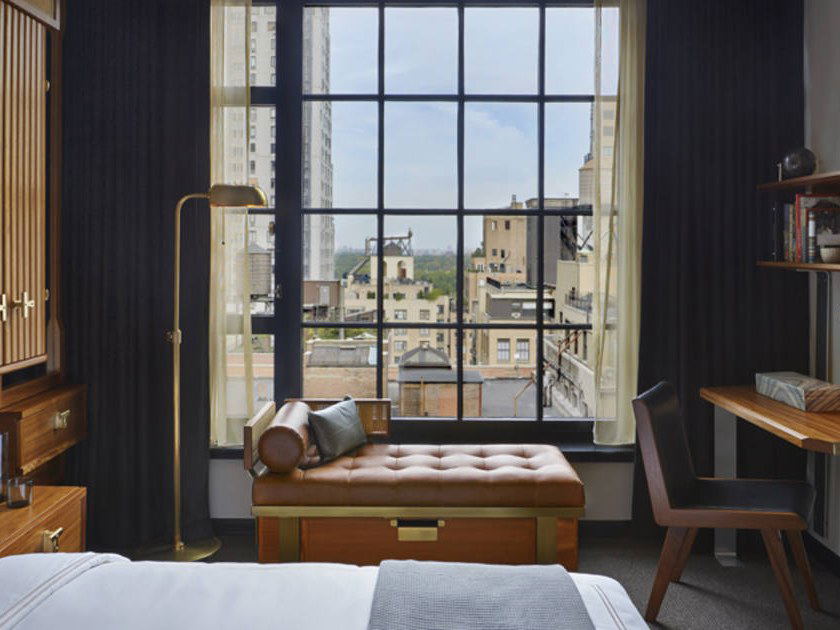 A stylish guestroom at Le Méridien New York, Central Park (Midtown) offers a Midtown Manhattan roofscape view.