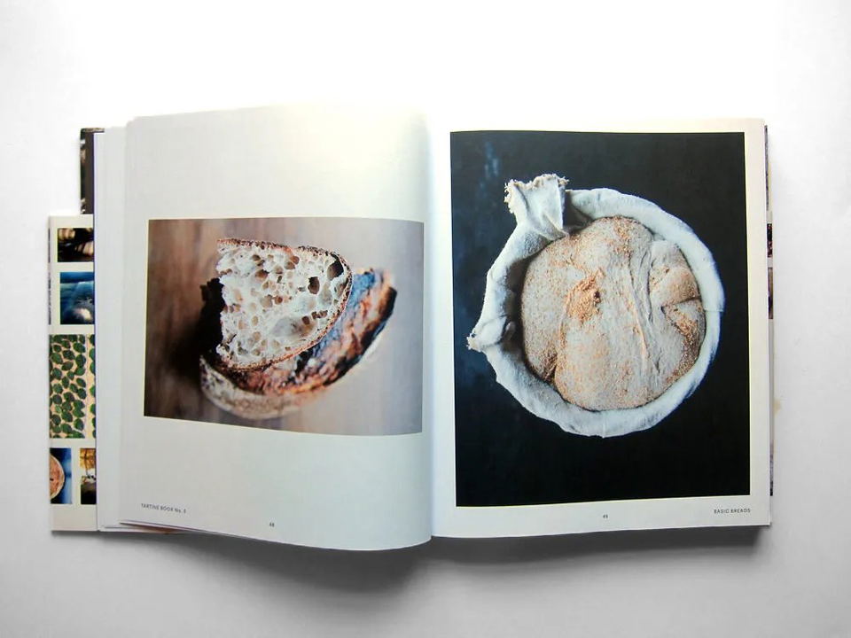 A copy of Chad Robertson's Tartine Book No. 3, open to pages 48-49 featuring rustic bread.
