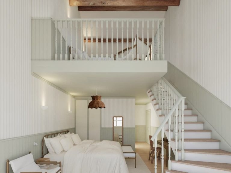 Château de Cîteaux offers a bright, two-story guest room with a lofted sleeping area and exposed wood beams.