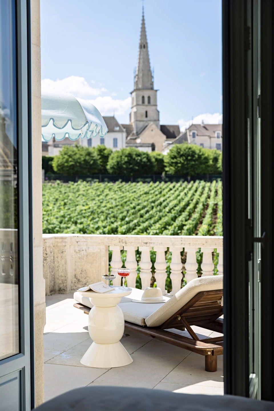 Château de Cîteaux Meursault offers a relaxing terrace with vineyard views and a distant church spire.