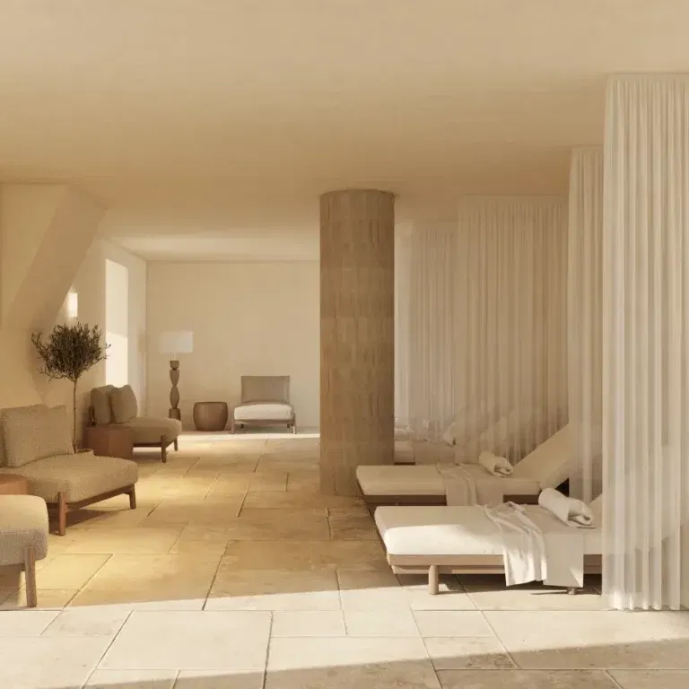Château de Cîteaux Meursault's Spa Alaena offers a serene retreat with heated loungers and sheer curtains.