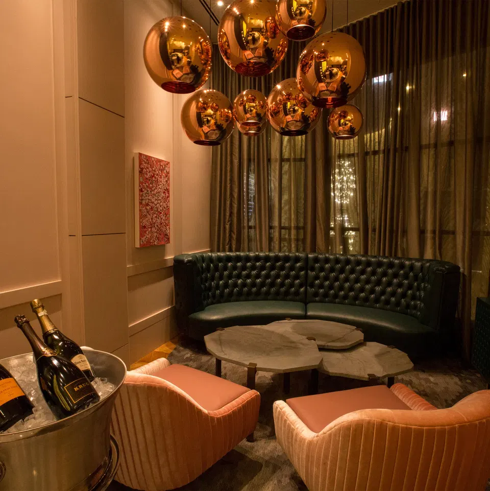 Esquire (Gold Coast) showcases striking copper orb light fixtures creating a warm, inviting glow.