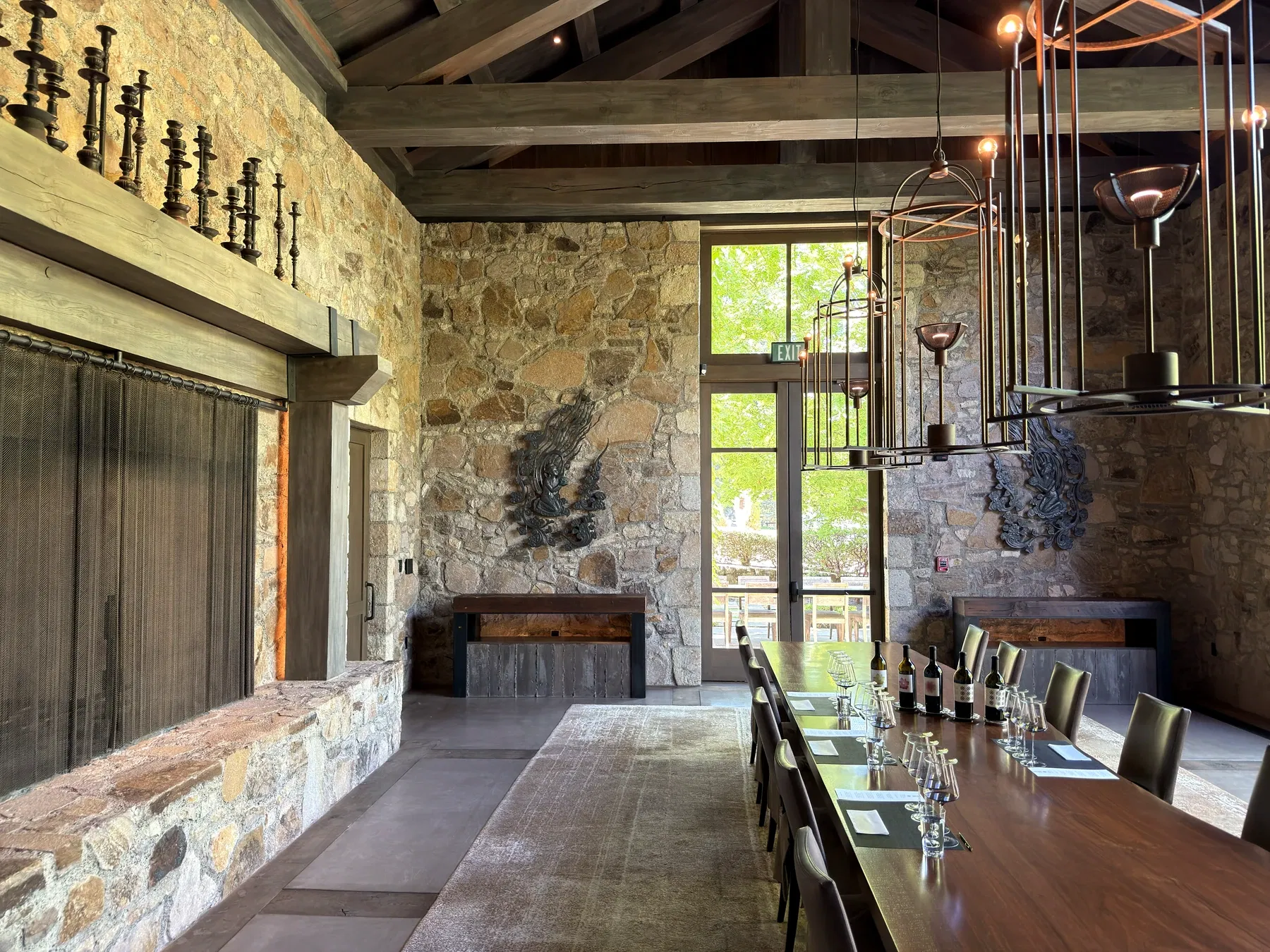 Private Dana Estates tasting room with stone walls, long table and courtyard windows