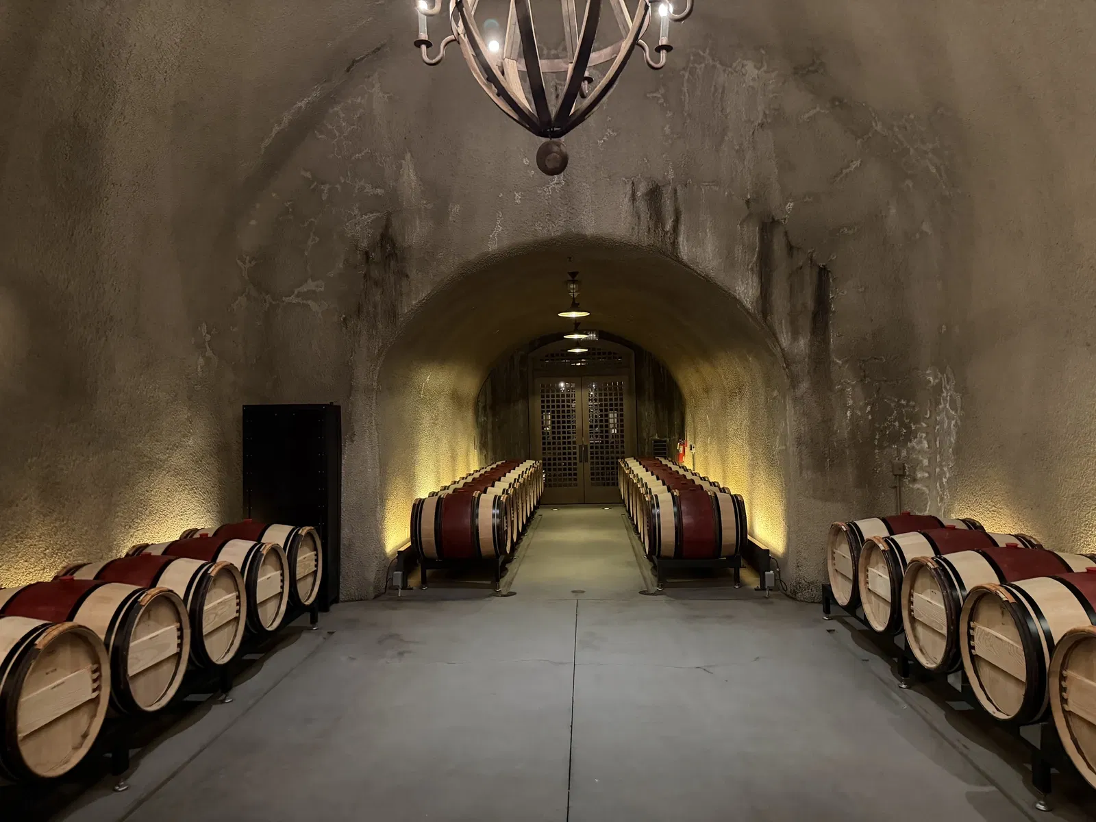 Long arched cave lined with Cabernet barrels beneath Dana Estates