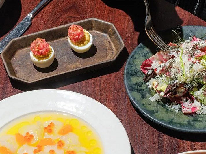 Darling West Hollywood's new menu features deviled eggs, a vibrant salad, and a citrusy scallop dish.