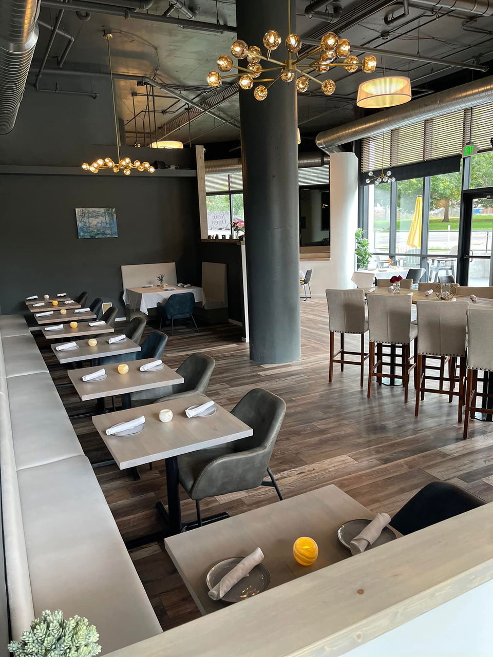 Ollie & Park’s (Denver) features striking modern chandeliers illuminating the dining space.