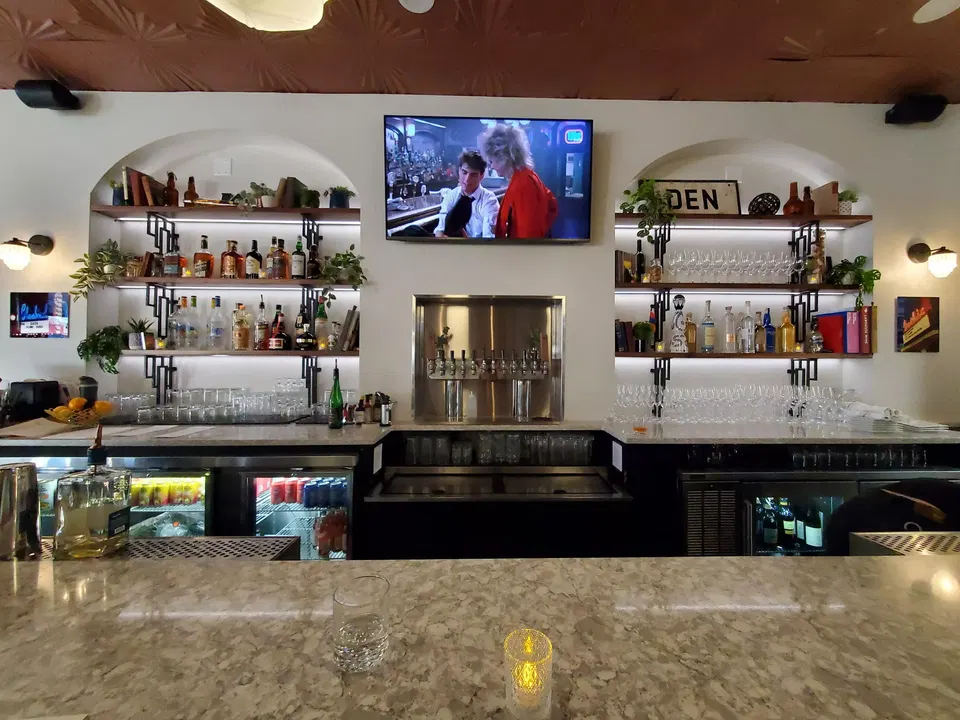 The W (East Colfax) features a striking brown ceiling with a repeating starburst pattern.