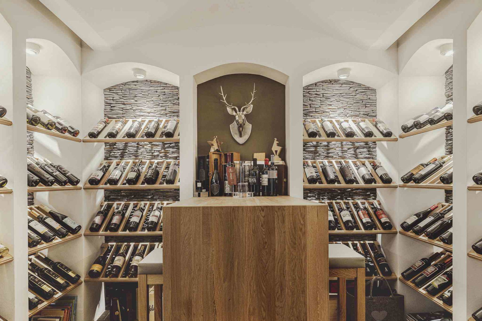 Wine and Drink Options feature a striking deer head mount above the central wooden counter.