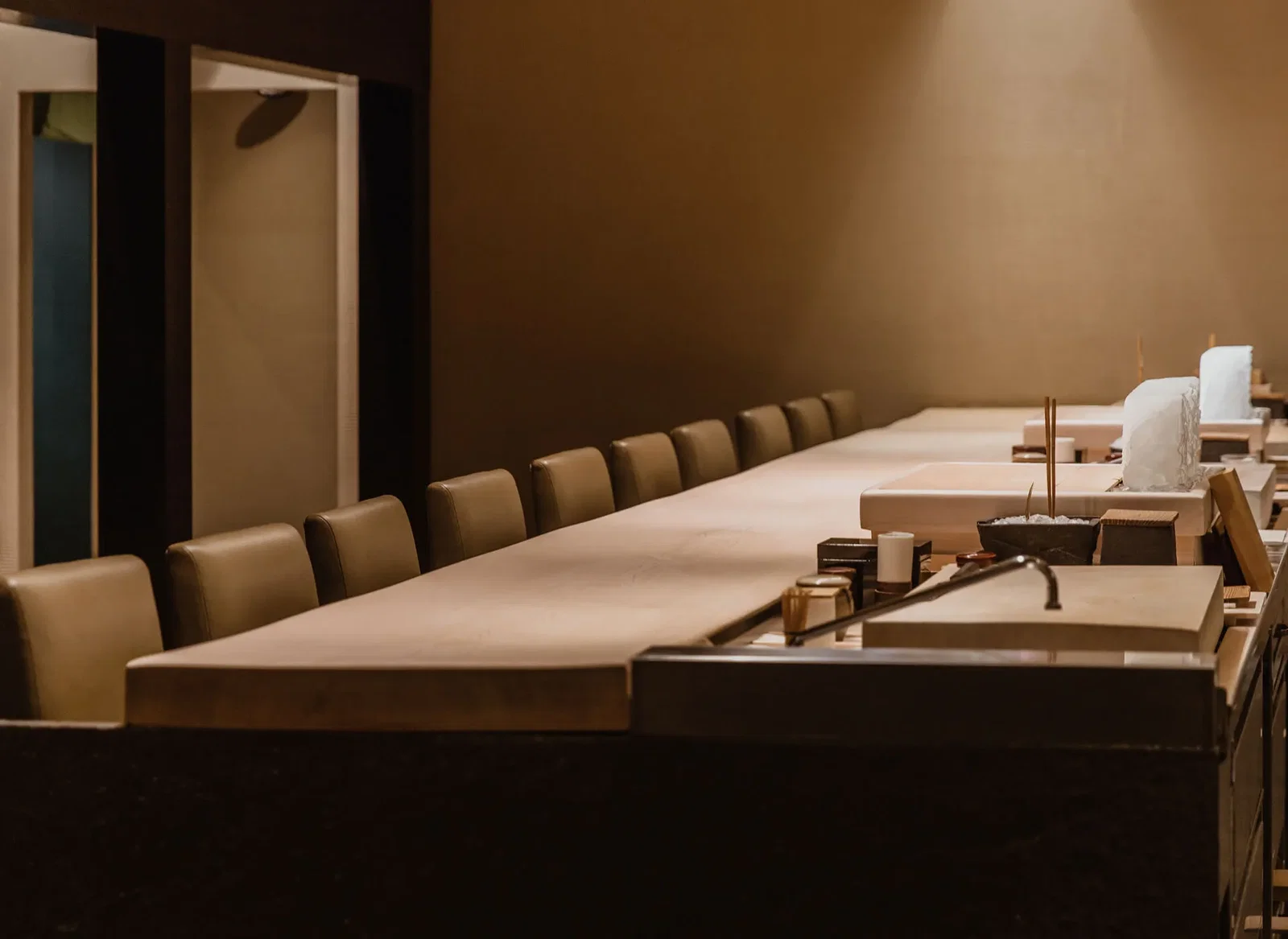 What's Next for Masa, featuring a long, light-toned wooden counter.