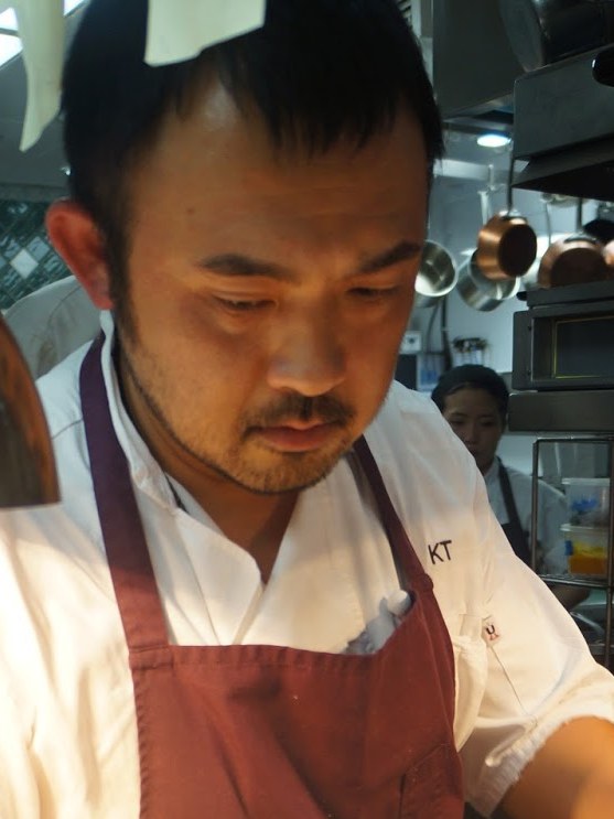 A chef meticulously plates a dish at Mélisse, offering a glimpse into The Chef's Counter Experience.