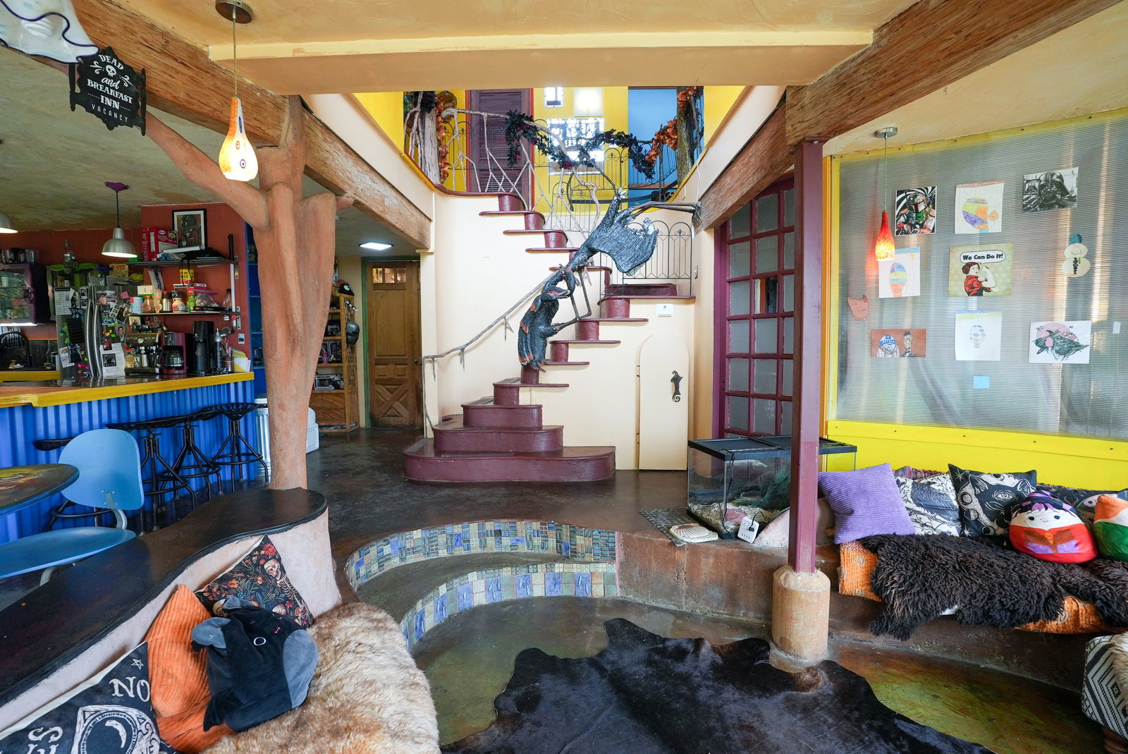 The Inn's Continued Appeal features a striking dark sculpture adorning its eclectic staircase.