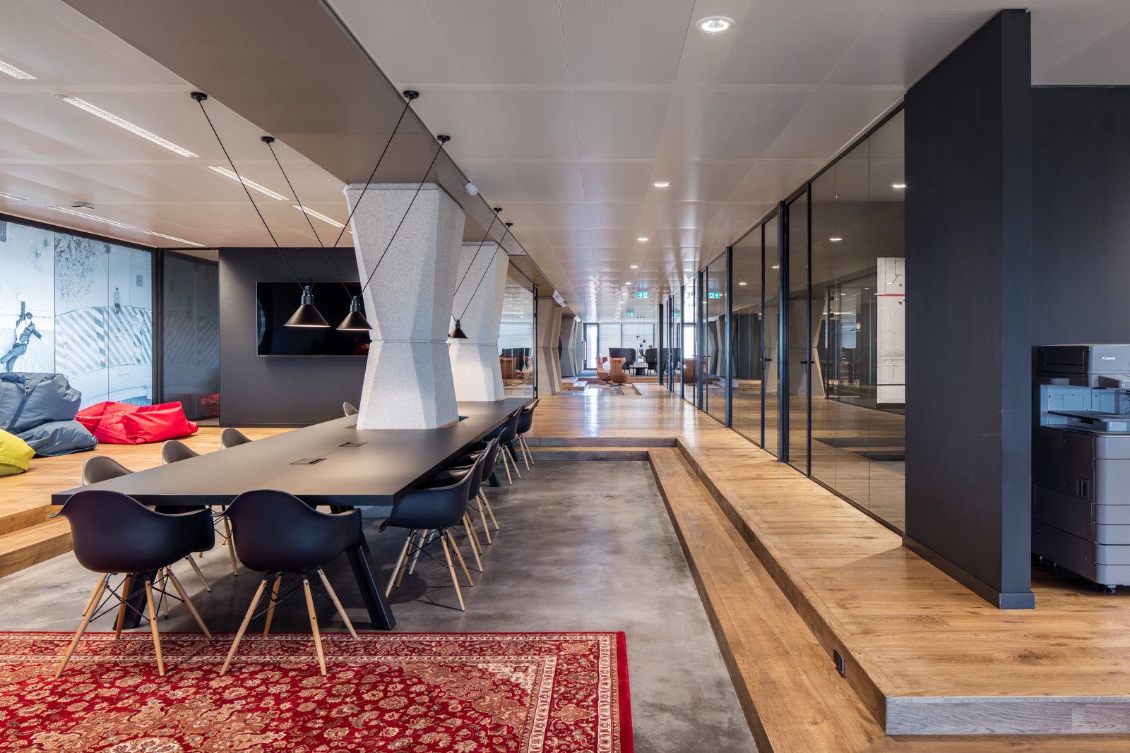 Conclusion, a vibrant red patterned rug adds a striking touch to the modern interior.