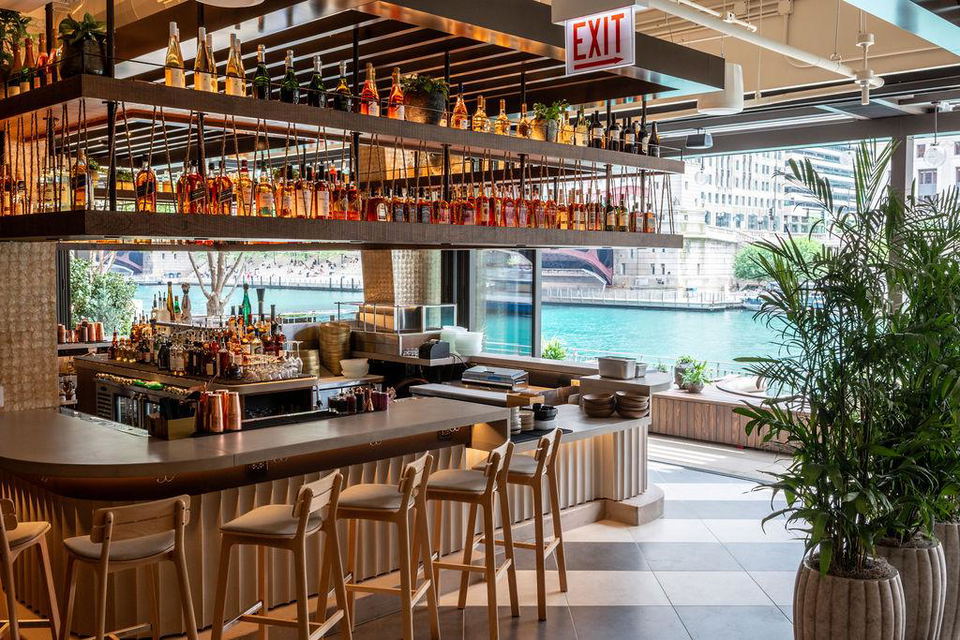 Naia Chicago's bar and riverfront terrace offer stunning views of the Chicago River and Riverwalk.