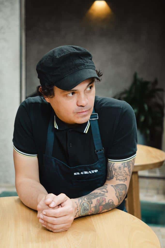 Álvaro Clavijo, one of the featured chefs, at a wooden table.