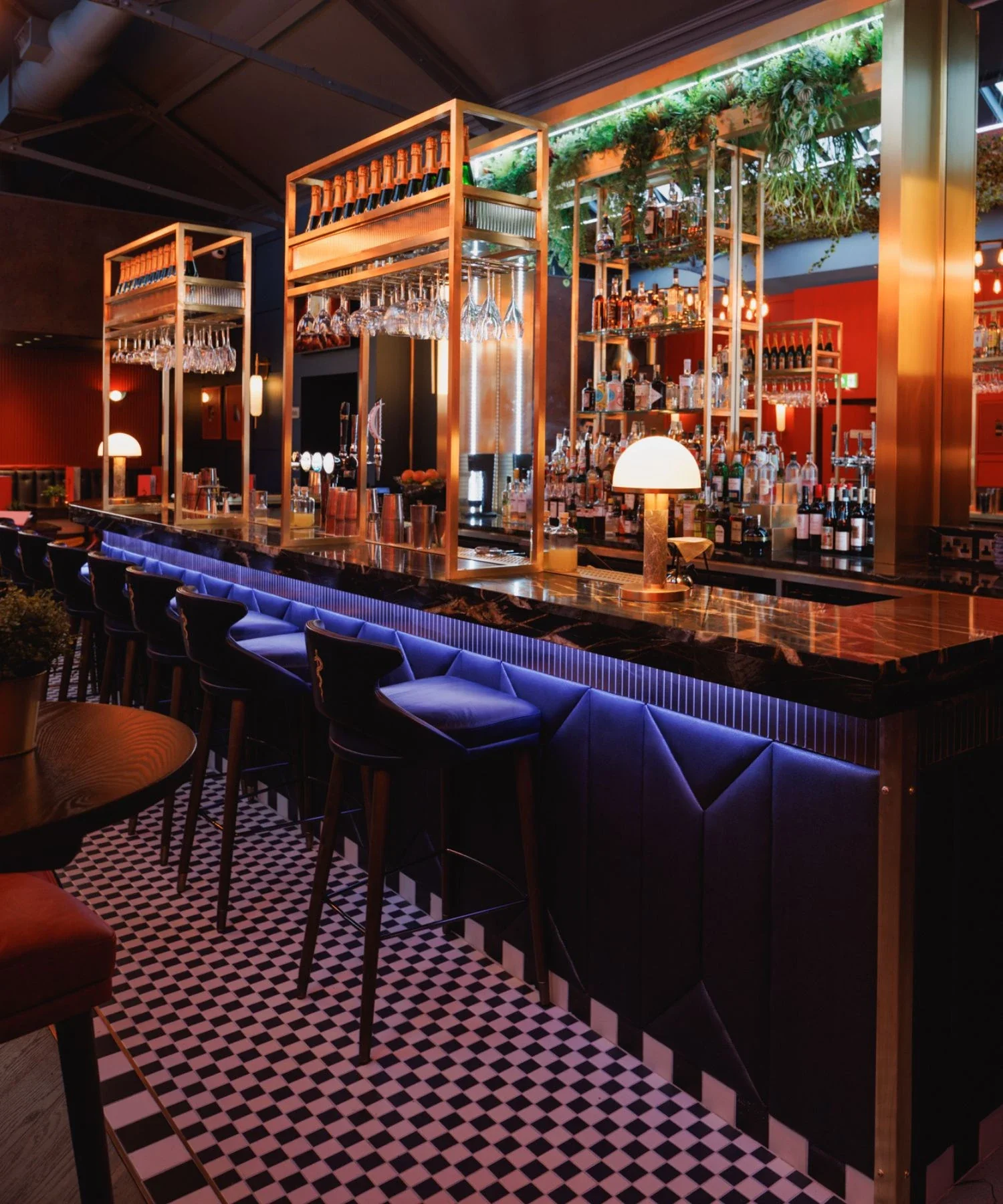 The Cocktail Menu and Drinks, highlighted by the striking blue under-bar lighting.