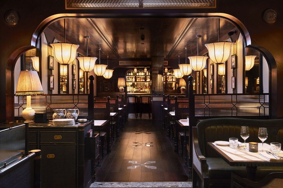 Gymkhana (DIFC) features a striking dark wood floor with illuminated cross patterns leading to the bar.