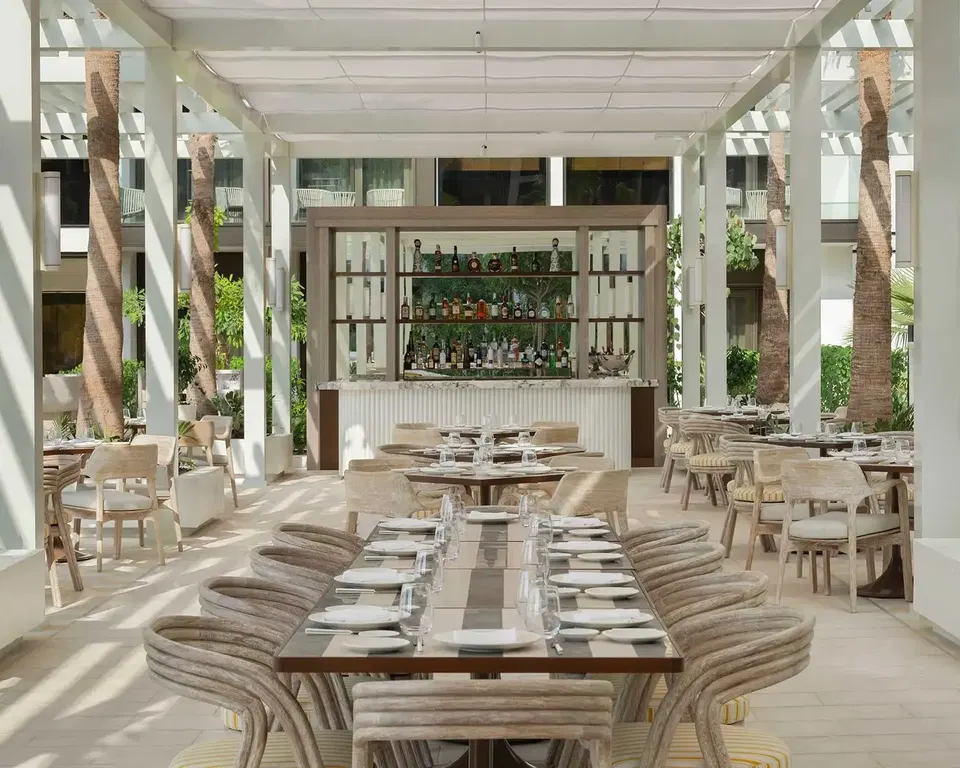 Unnamed LA Italian-American Restaurant (Jumeirah) offers an airy dining space under a white pergola.