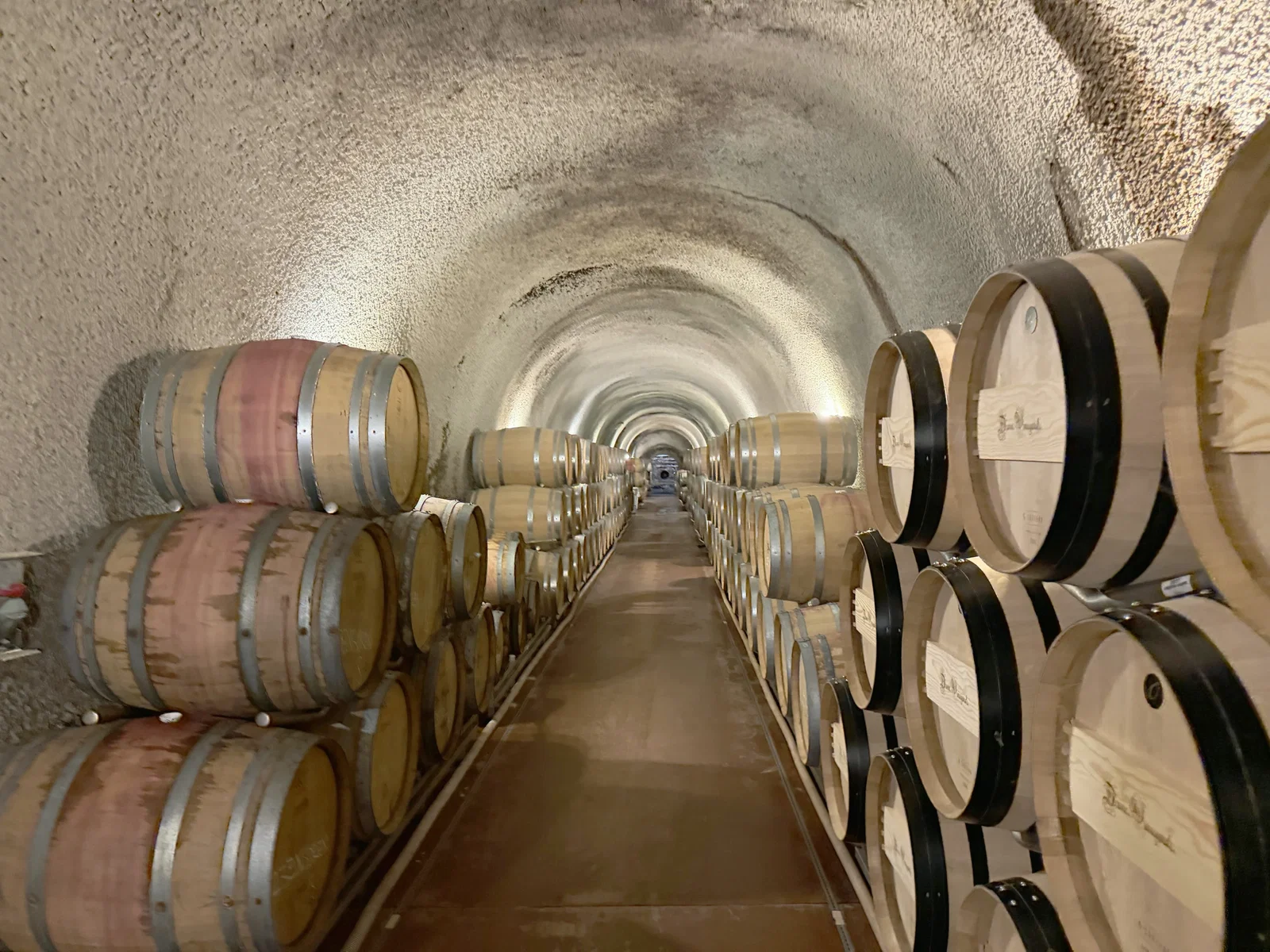Long humid 1989 cave lined with French oak barrels at Dunn Vineyards