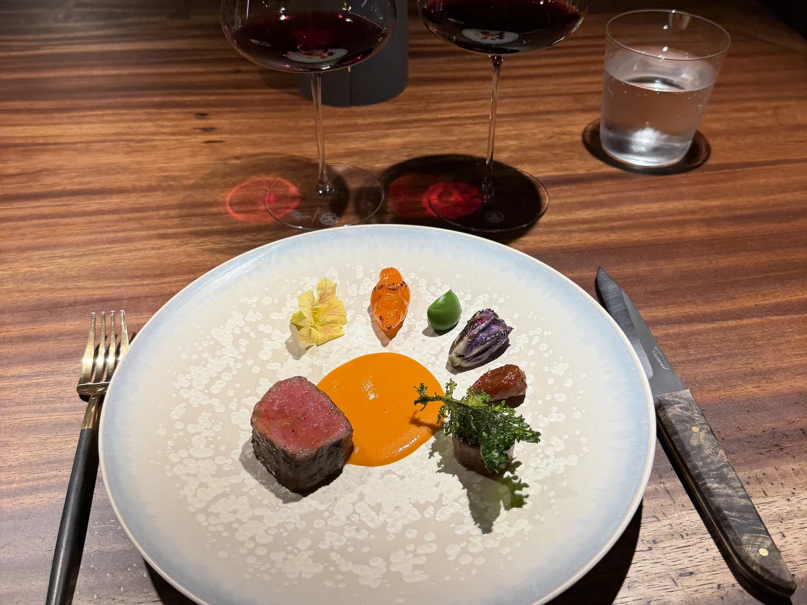 Beef course with separate farm vegetables and sauces at Enclos in November 2025