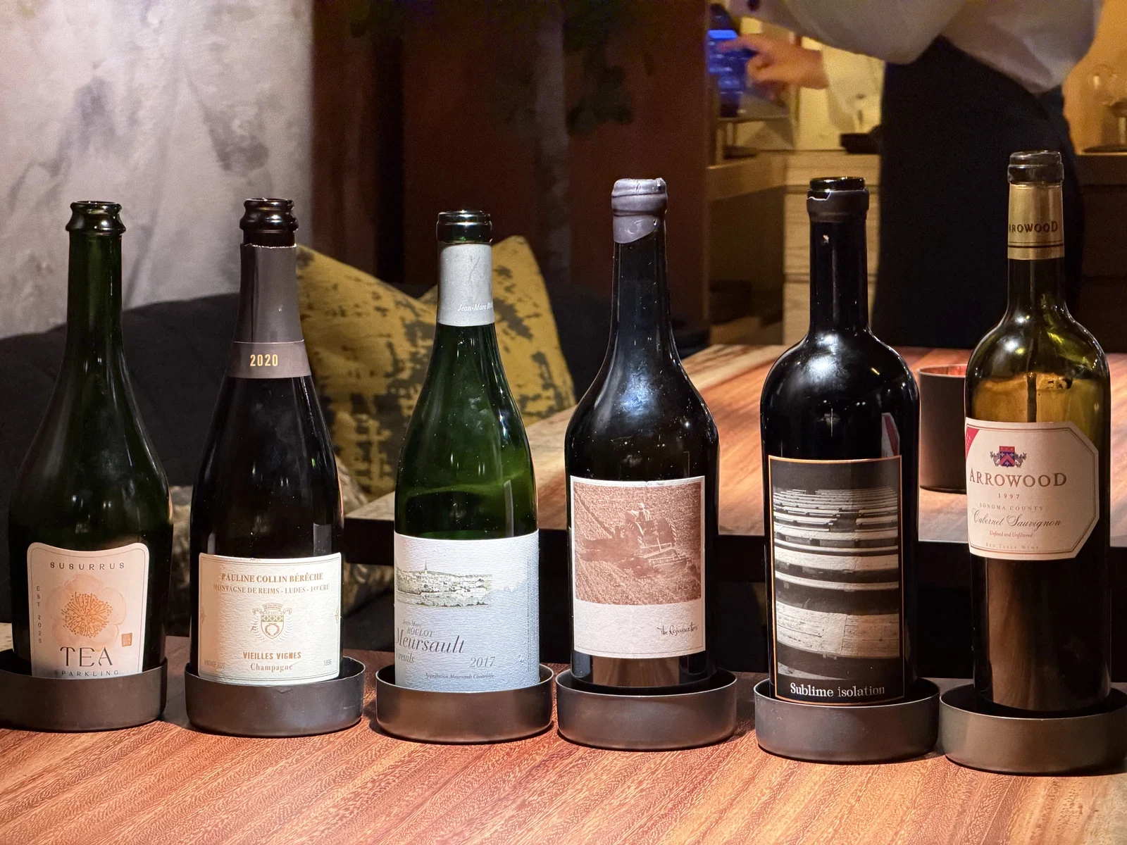 Wine and sake bottles from the Enclos beverage progression after the July 2026 dinner