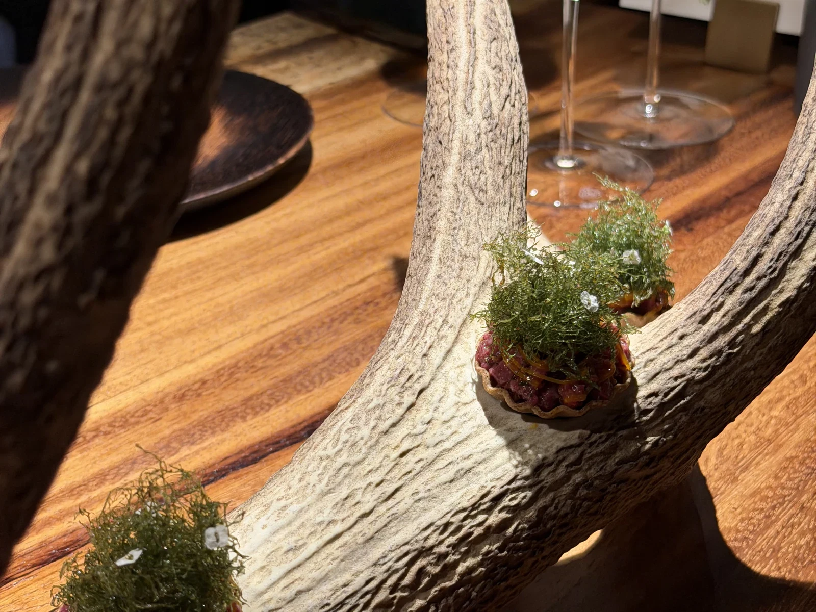 Venison tartare canapes with fried lichen presented on antlers at Enclos