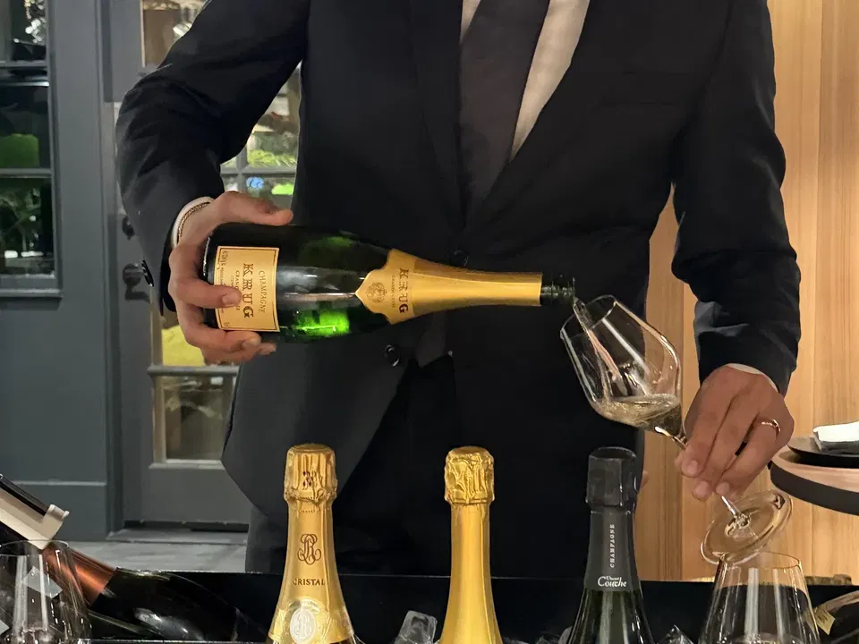 Champagne poured tableside from the Enclos cart during the first visit