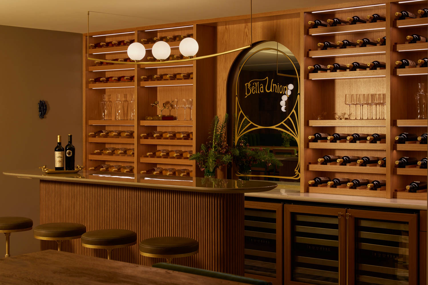Winemaking Style features a striking arched mirror with intricate gold detailing.
