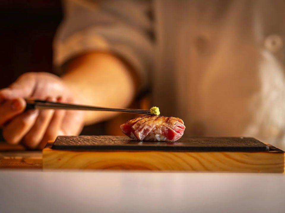 Miuna on Four Seasons I: A chef meticulously places nigiri with wasabi on a Hinoki wood counter.