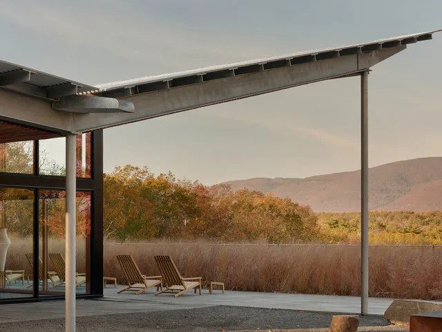 Piaule Catskill offers a serene escape with modern architecture and a view of autumn foliage and distant mountains.