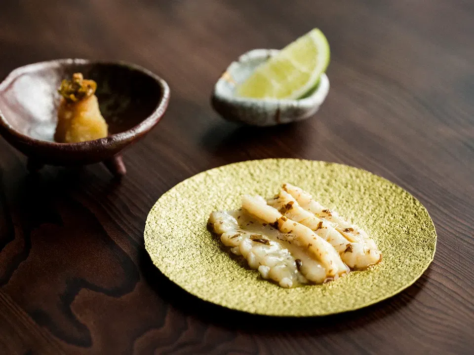 A precisely plated coastal tasting-menu course at Harbor House restaurant