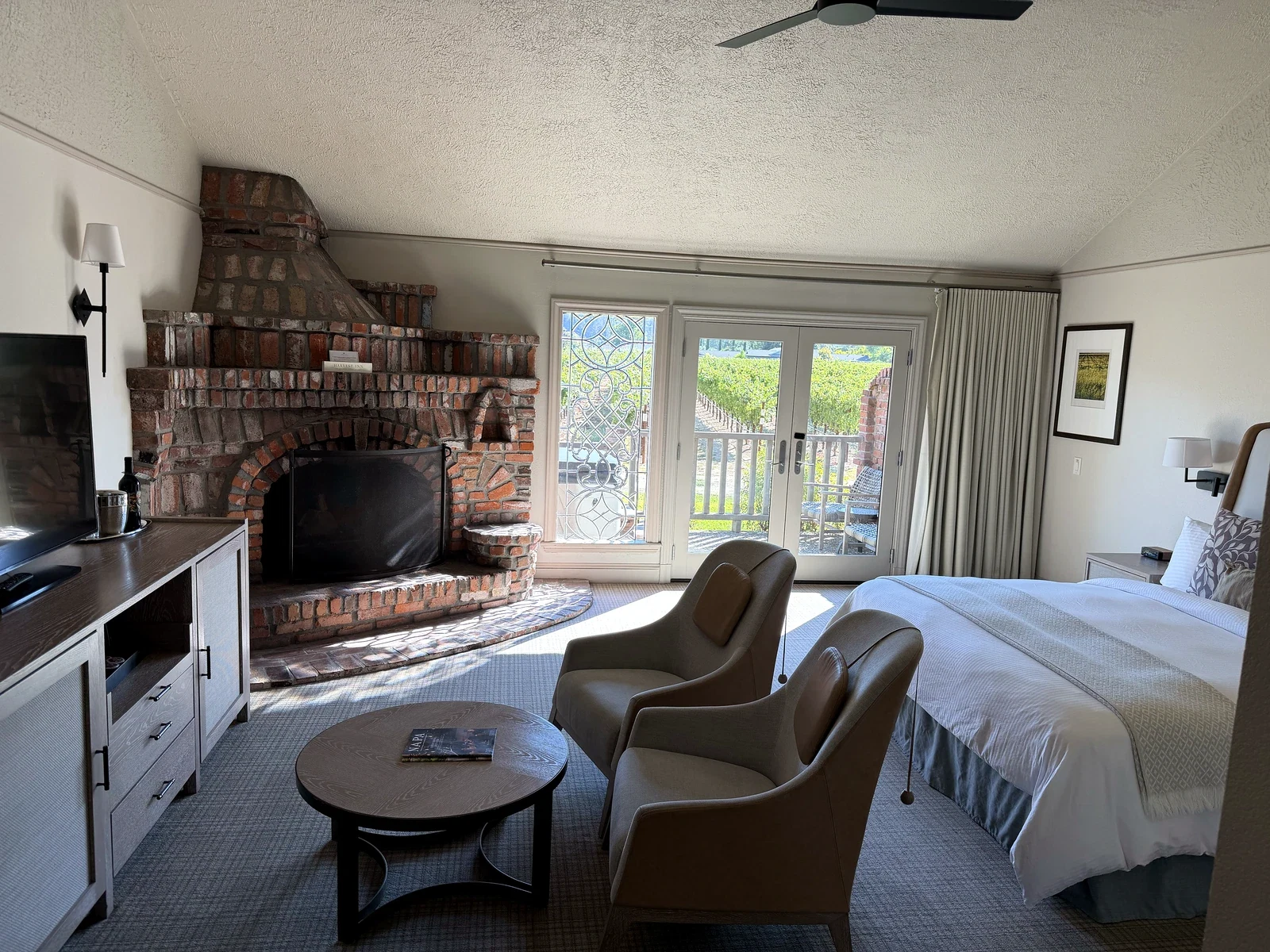 Harvest Inn Vineyard View Collection Spa room with king bed and large brick fireplace
