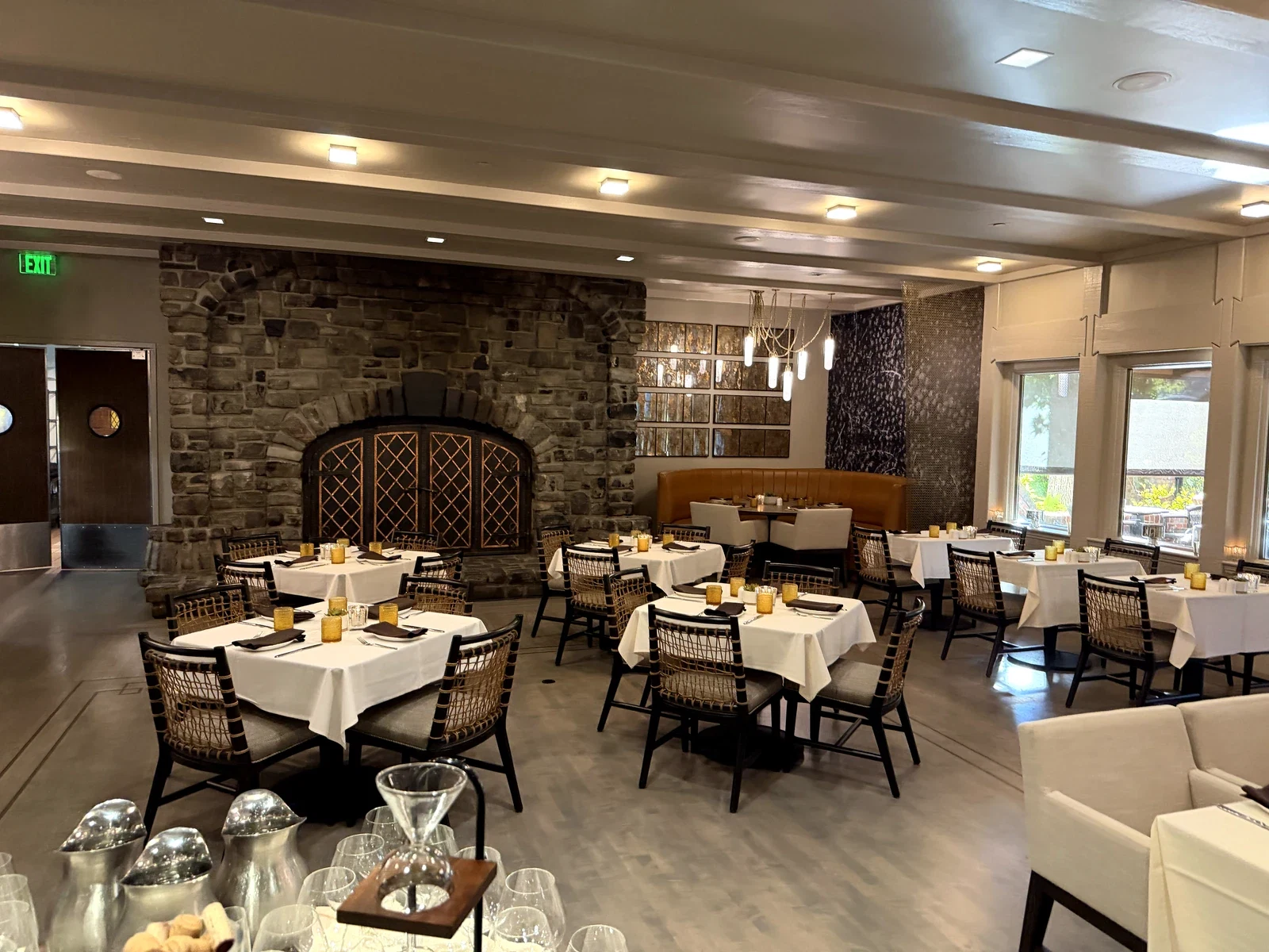 Harvest Table dining room with large brick fireplace and windows onto the gardens