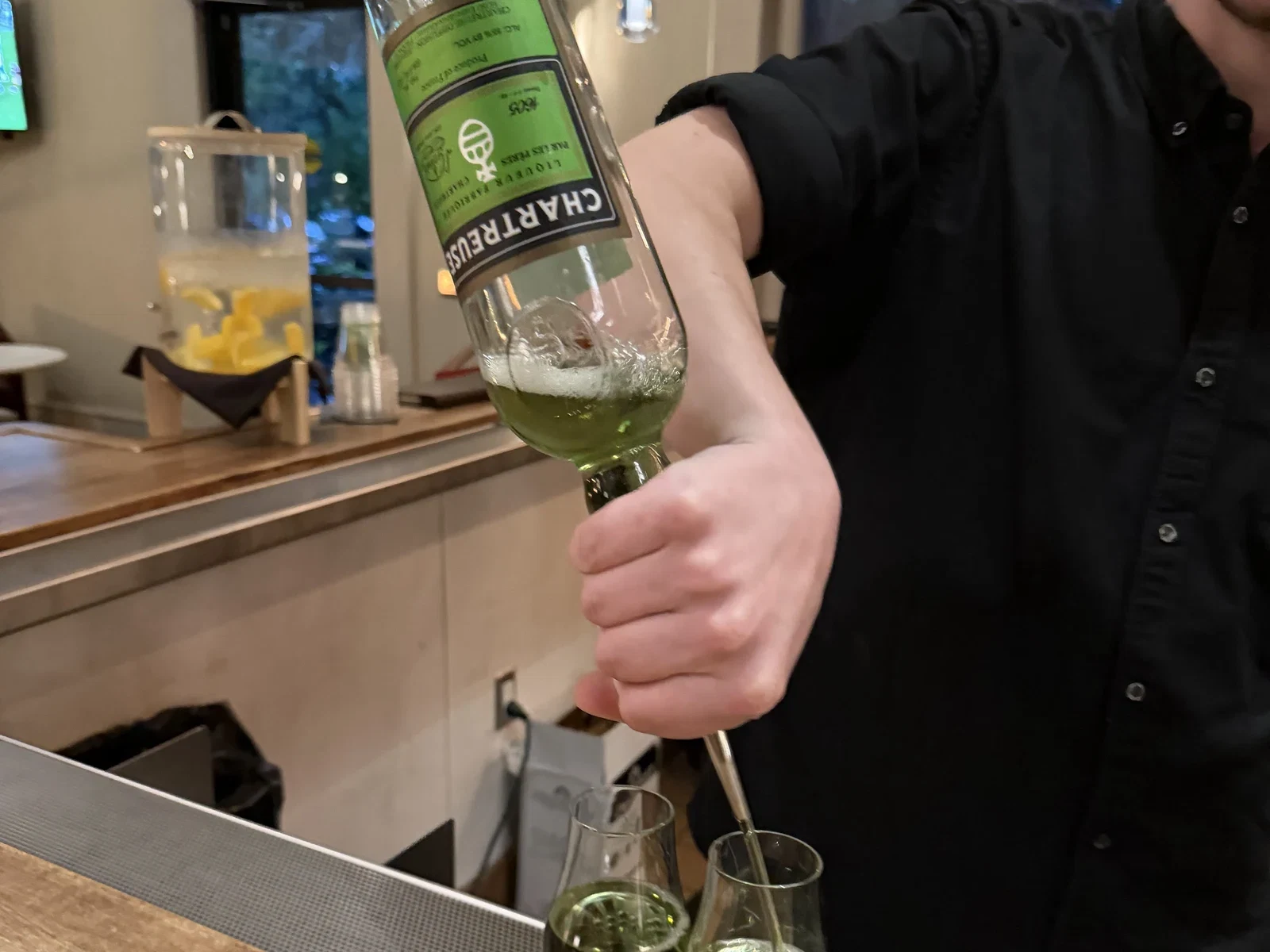 Bartender Jesse Earl pouring green Chartreuse at Harvest Table in St. Helena