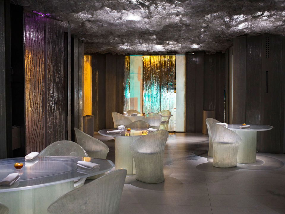 Modern restaurant interior with unique translucent tables and chairs