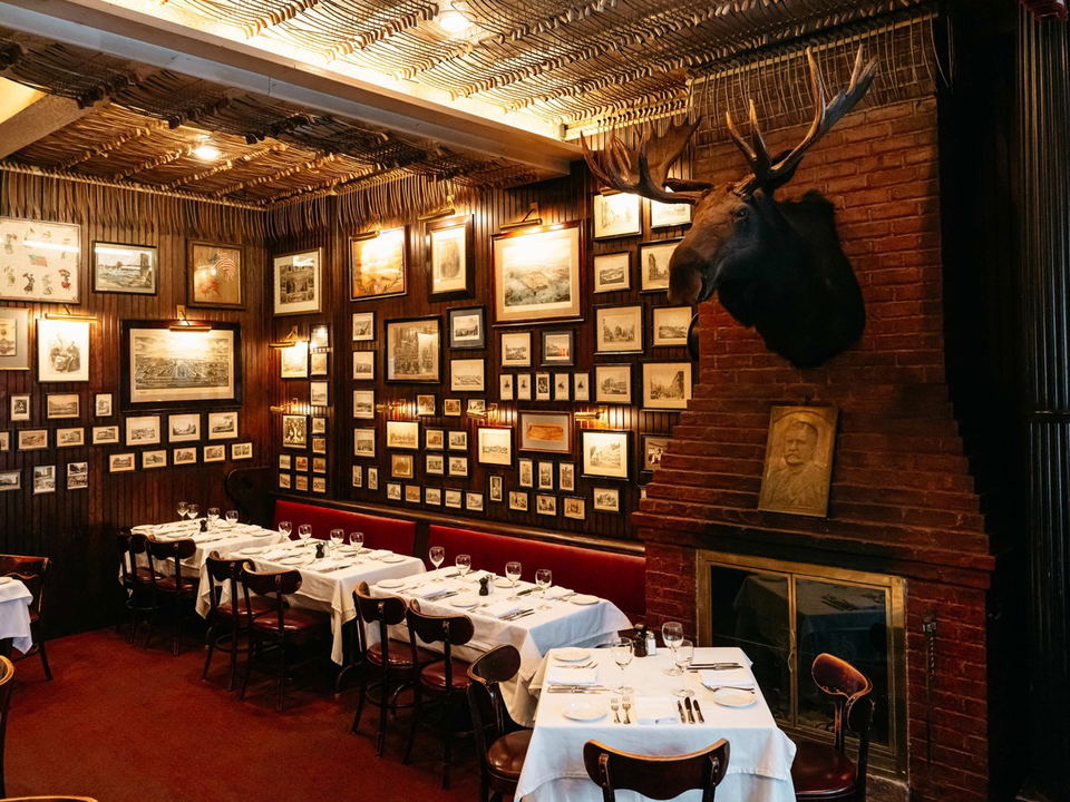 Keens Steakhouse's historic dining room, with its pipe collection and classic NYC steakhouse atmosphere.