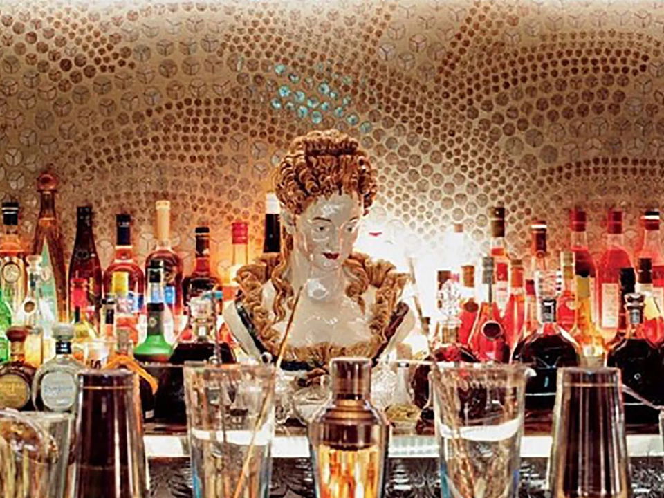5 Hertford Street's ornate bar, featuring a decorative bust and hundreds of backlit spirit bottles.