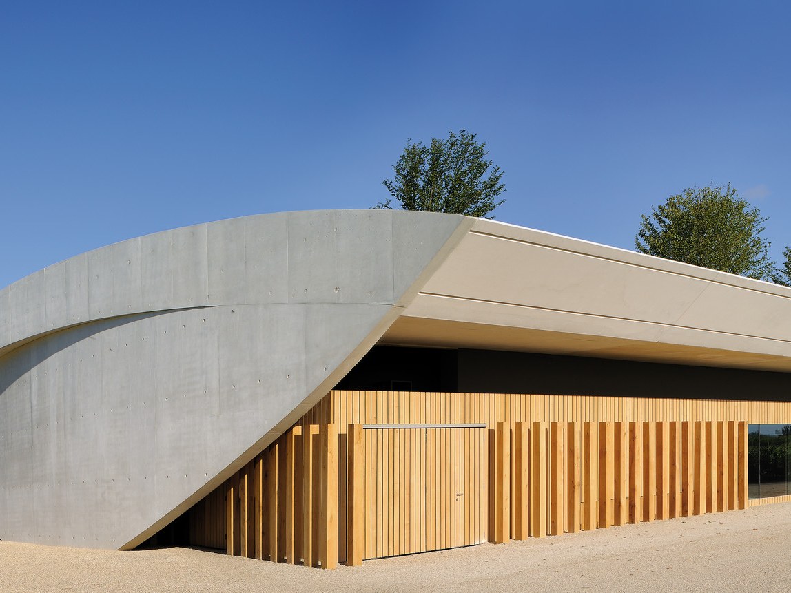 Château Cheval Blanc: Portzamparc's curved concrete and timber winery blends into the Saint-Émilion vineyard.