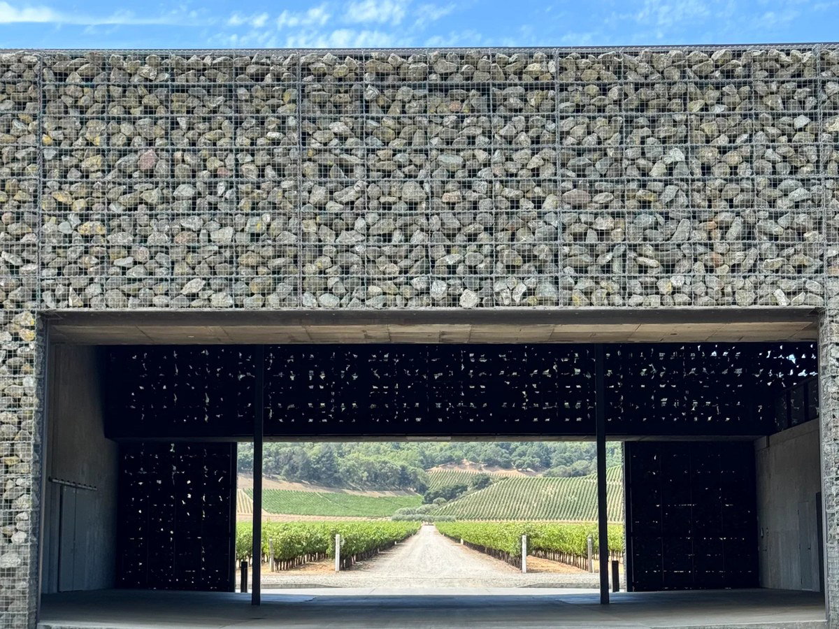 Dominus Estate's gabion walls frame the Napanook Vineyard, showcasing Herzog & de Meuron's design.