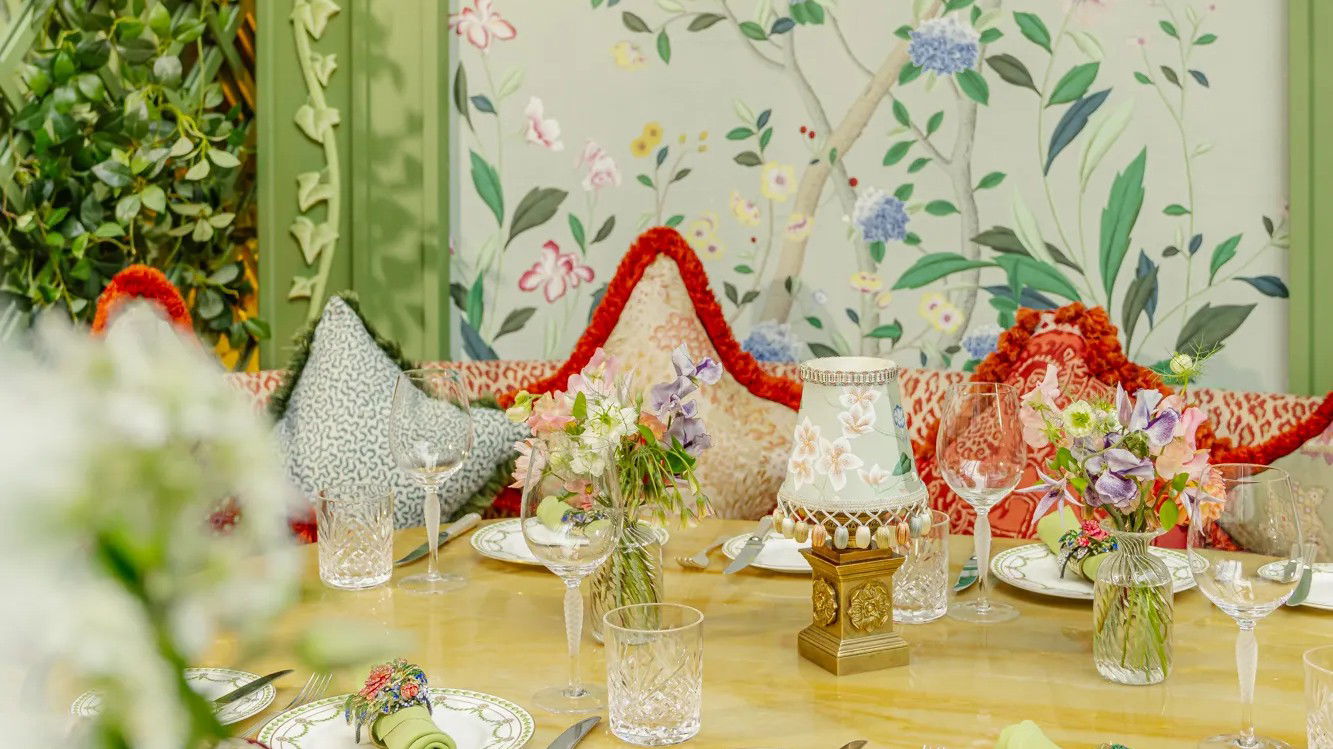 Annabel's maximalist botanical interior features de Gournay wallpaper, leopard print, and elaborate table settings.