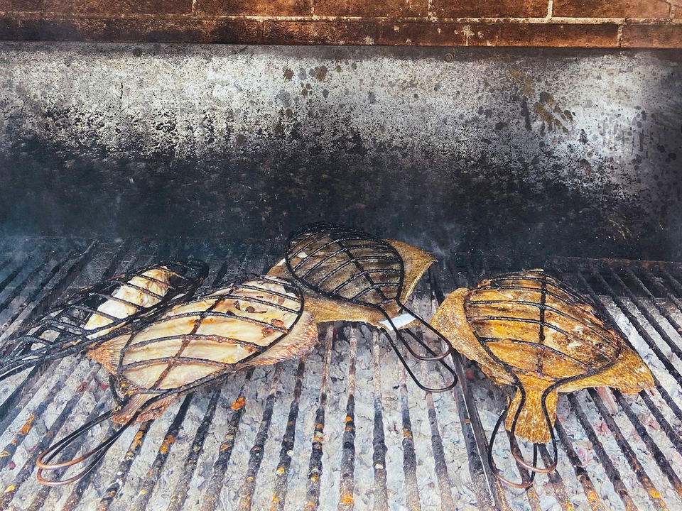 Three whole flatfish grill over charcoal, a worthy alternative if Asador Etxebarri doesn't open up.