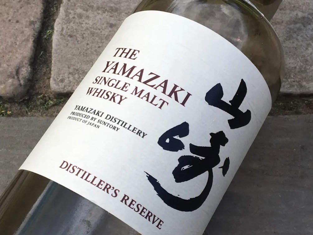 A close-up of a Yamazaki Single Malt Whisky Distiller's Reserve bottle label, showing the brand name, type of whisky, and distillery information.