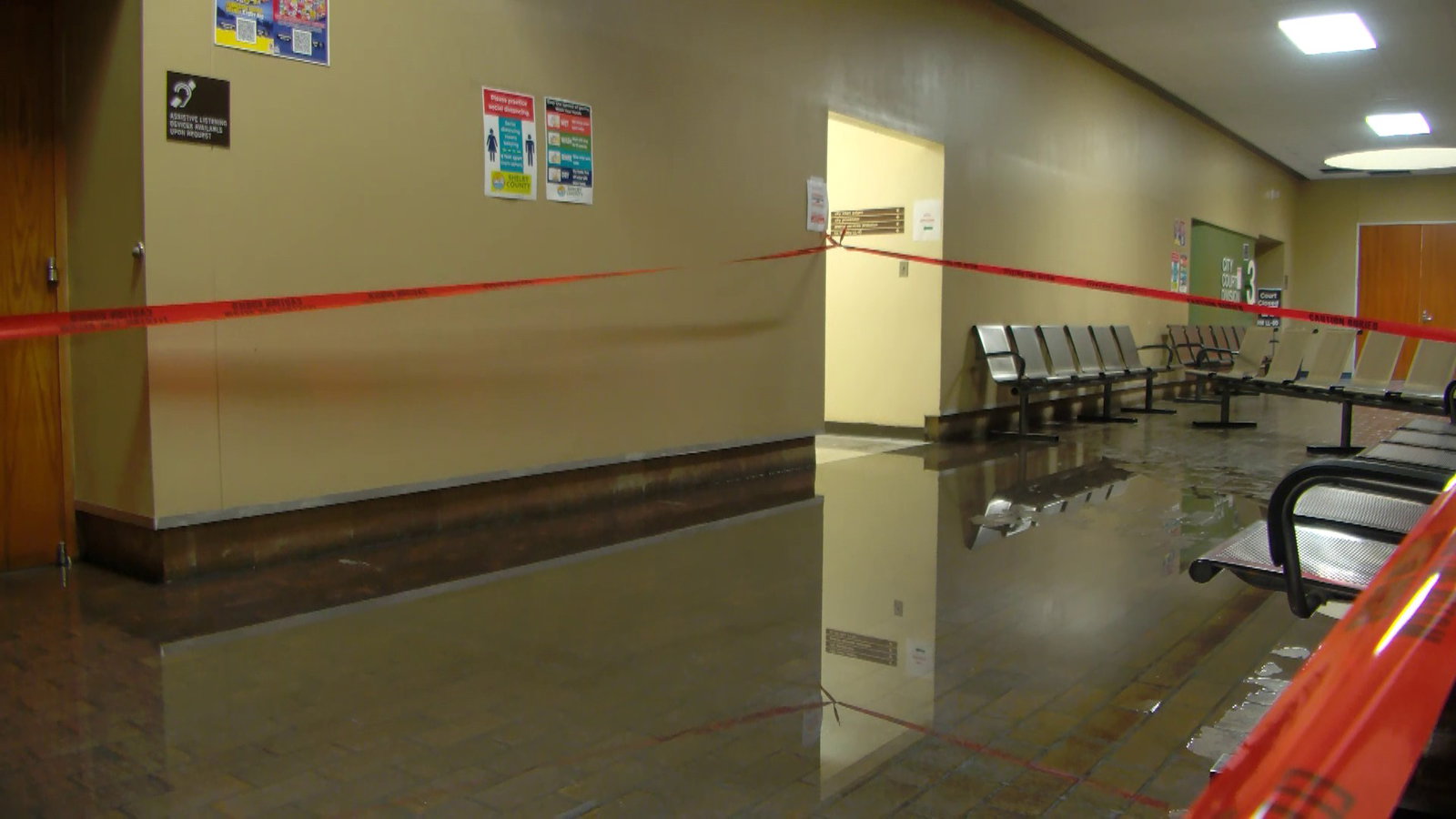 Monday: Depart, a vivid red tape stretches across the water-filled space.