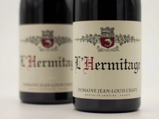 Two bottles of Domaine Jean-Louis Chave L'Hermitage rouge stand side-by-side on a light, neutral background.