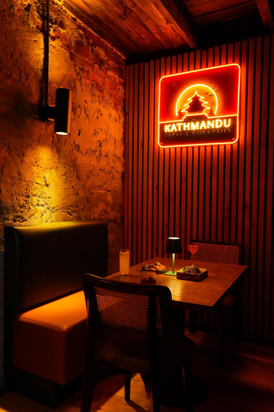 Kathmandu U Street (U Street) features a vibrant neon sign illuminating the cozy dining area.