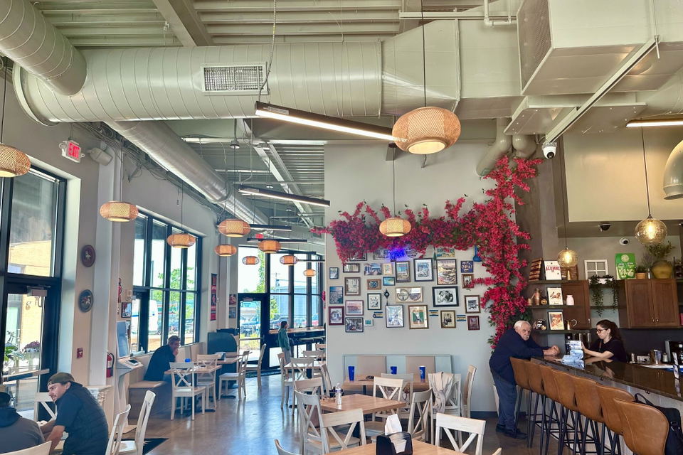 Marathon Deli & Grill (Kensington) features a vibrant wall adorned with bright pink floral decor.