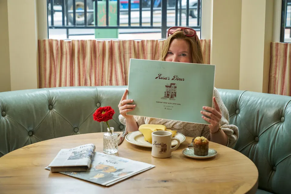 Rosa’s Diner (Downtown) showcases its menu with a distinctive illustration of a building.