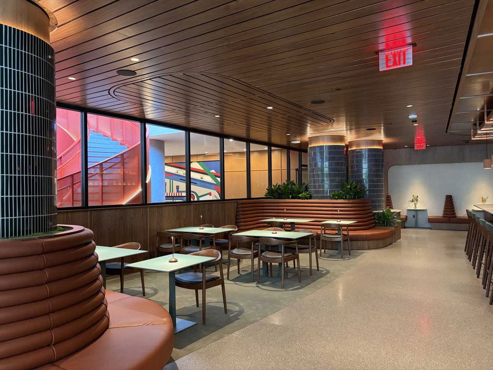 Constellation (National Landing) offers a stylish dining room with banquette seating, tiled columns, and large windows.