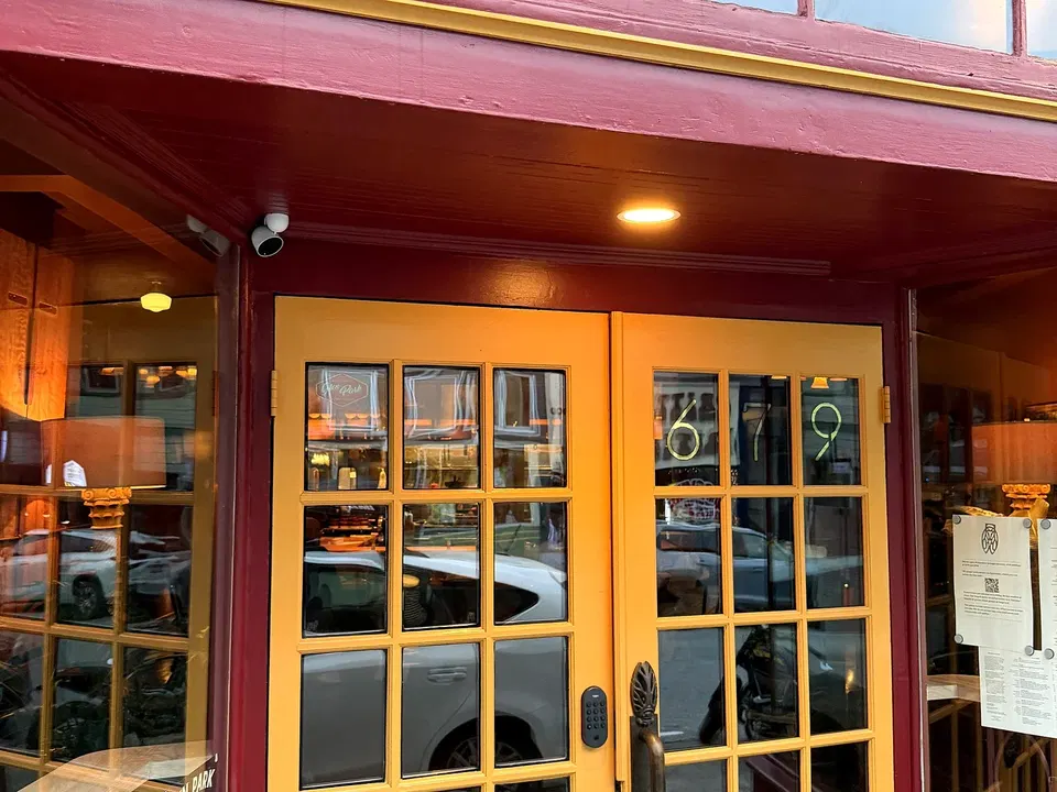 La Cigale’s deep red storefront and glass doors on Chenery Street in Glen Park